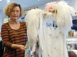 Nava Ottenberg holds up a fully accessorized flapper's outfit, including a feather boa, pearls and 12-inch cigarette holder.