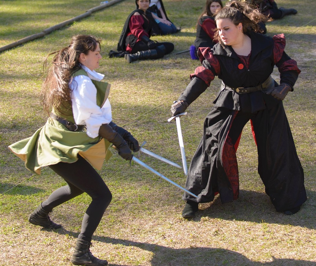 Sunny Andrei, left, displays her combat moves during the Hoggetowne Medieval Faire.