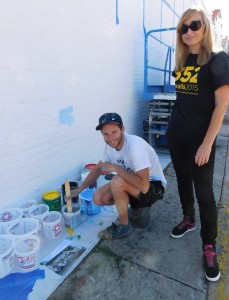 Street artist Franco Fasoli JAZ poses with 352walls curator Iryna Kanishcheva as he begins painting his mural on the Shadow Health wall.