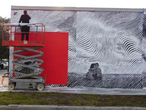 Andrew Antonaccio applies finishing touches to the mural he created with 