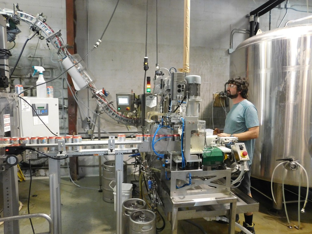 John Denny keeps an eye on his canning operation at First Magnitude Brewing Co.