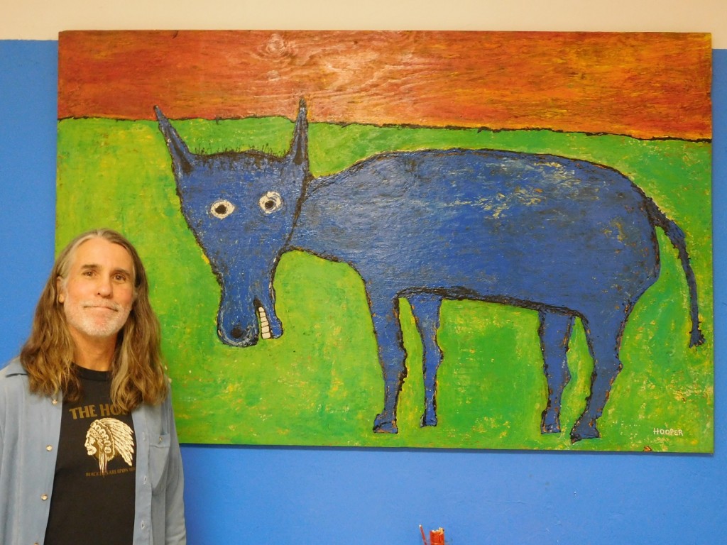 Milan Hooper and his painting Blue Burro. His work is on display through February at the SoMa Art Media Hub, 601 S. Main St.