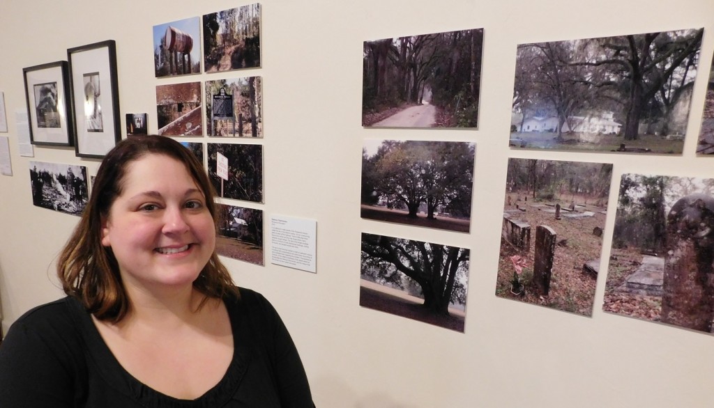 Rebecca Fitzsimmons and some of the photographs she took while researching the Matheson Museum exhibit. Photo by Gainesville Downtown)