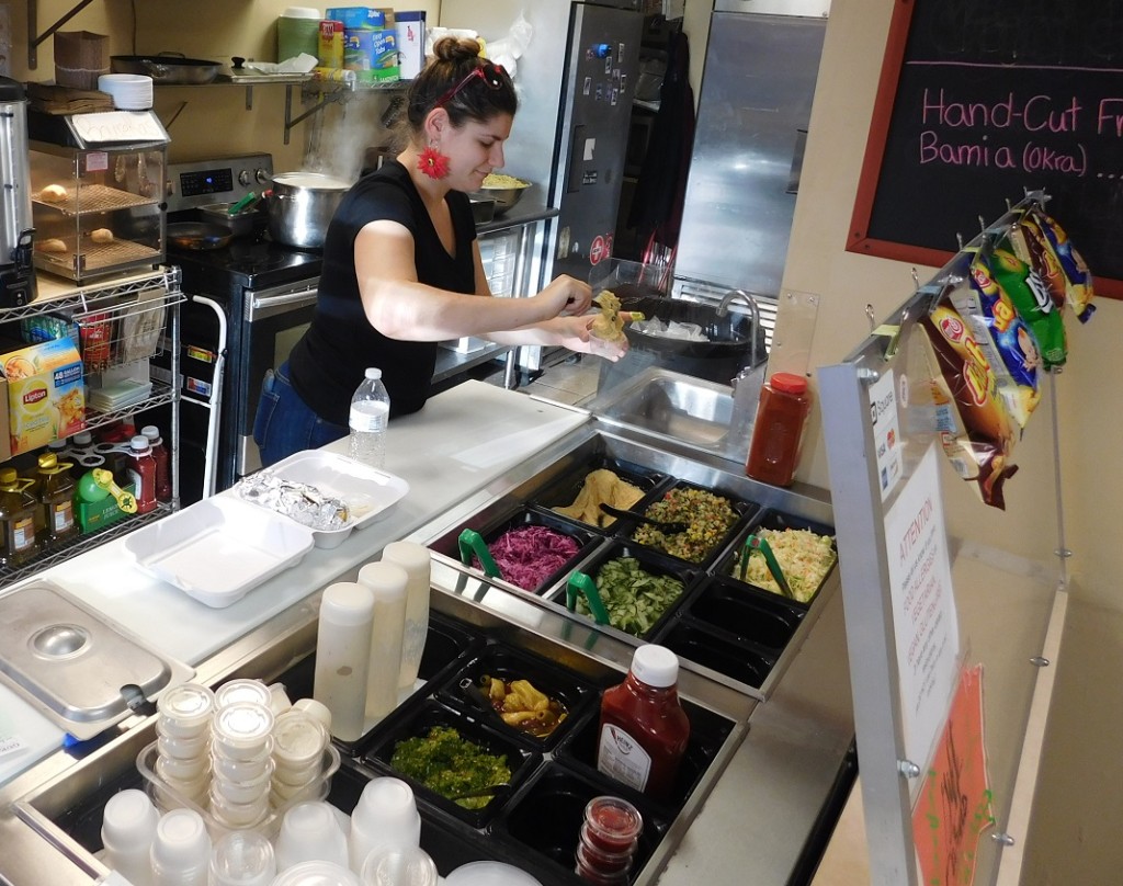 Yael Goldstein fills a customers order at Sababa.