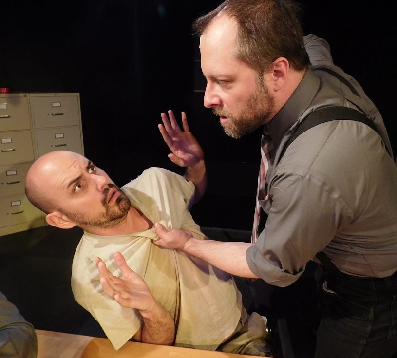 Ariel Adam Lishawa) threatens Katurian Kennan Liston) in a scene from The Pillowman.