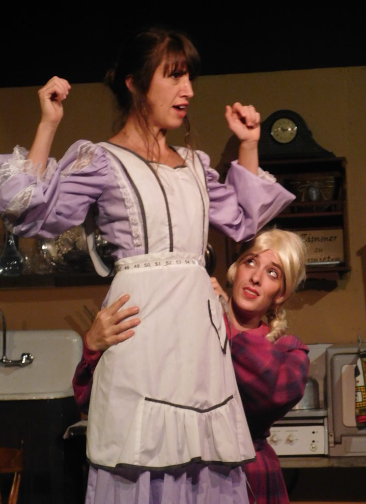 Gertrude Carlyn Howells) measures Louise Emily Snider Carvalho) for some new bloomers.