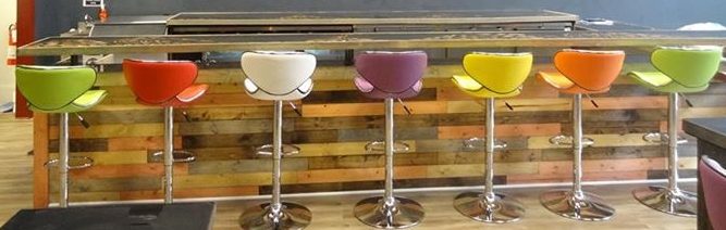 The colorful barstools at Elixir and the wood accents on the bar.