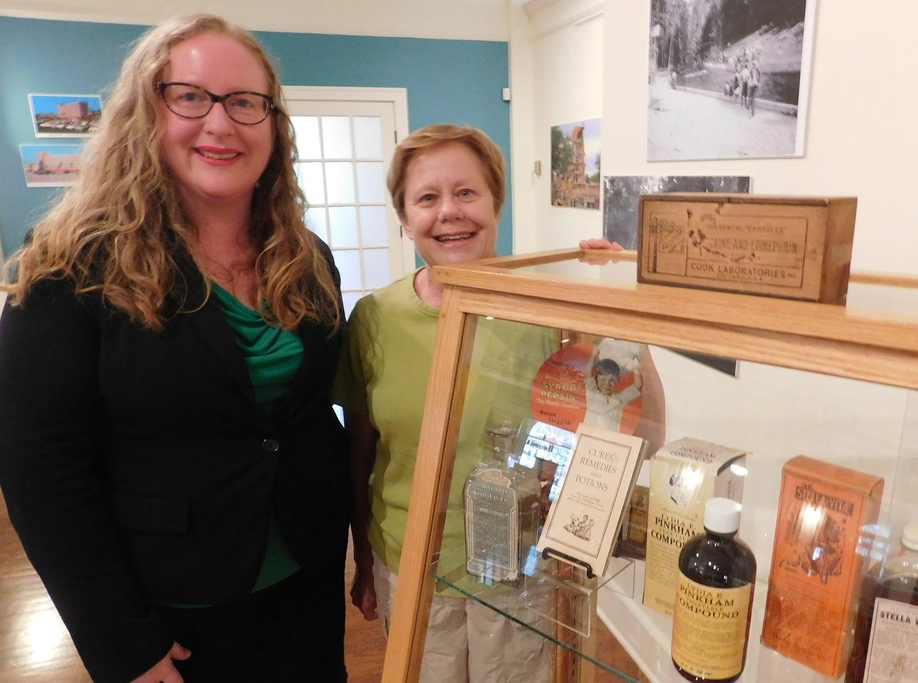 Matheson Museum Executive Director Peggy Macdonald and museum board member Mae Clark in front of a display case that is part of the Medical Milestones exhibit. )Photo by Gainesville Downtown)
