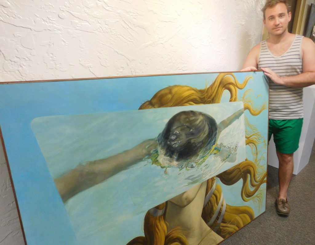 Adam Germann prepares to install John Wards painting "Venus."