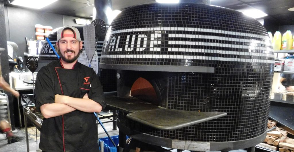 Executive Chef Matt Kepp in front of one of two wood-fired ovens at V Pizza Photo by Gainesville Downtown)