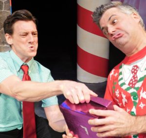 David Patrick Ford and Matthew Lindsay struggle over a gift. Photo by Gainesville Downtown)
