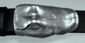 A silver alligator belt buckle, by Peter Senesac.
